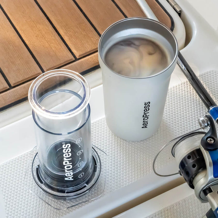 AeroPress Coffee Maker - Go Plus in cream with coffee inside on a table