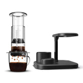 AeroPress clear coffee maker next to an organiser stand