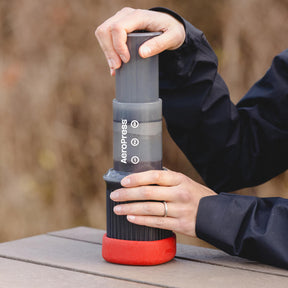 Making coffee with the AeroPress Go on a picnic table