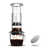 An AeroPress clear coffee maker with stainless steel filter